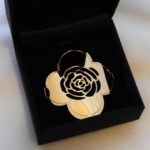 Voici la silhouette d'une rose découpé dans de l'or jaune. C'est la partie métallique d'un bracelet, elle viendra s'attacher au poignet au moyen d'un ruban par les deux trous percés latéralement.